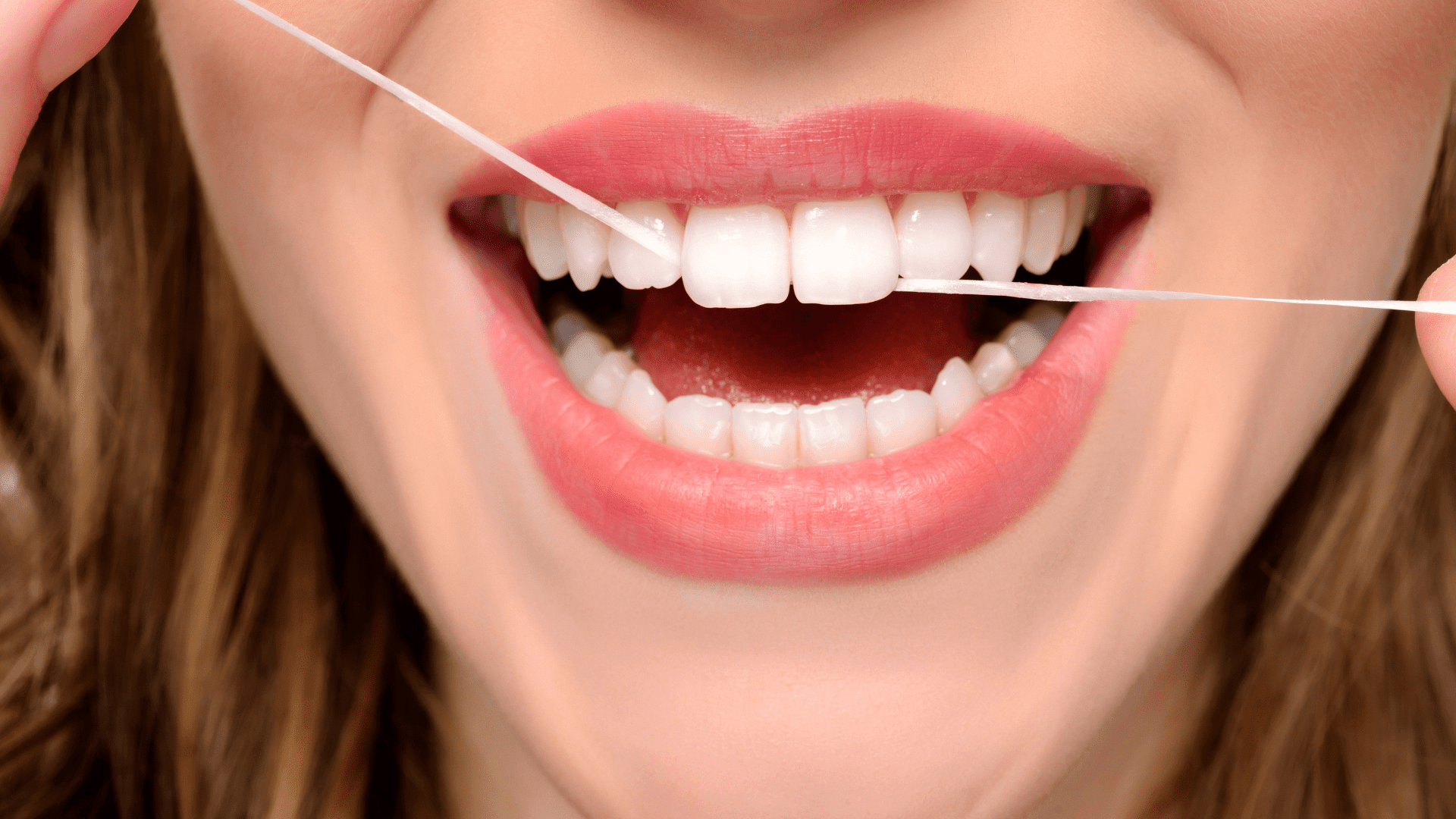 Woman Flossing Teeth | Smiles on Florida